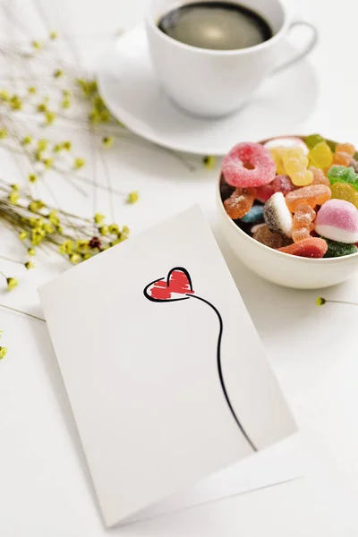 Postcard with a red heart on a table — Stock Photo, Image