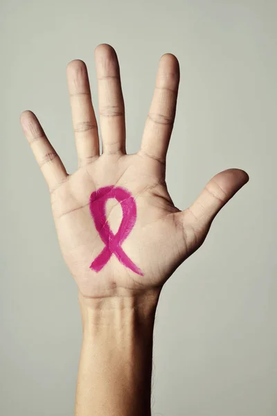 Pink ribbon in the palm of a man — Stock Photo, Image