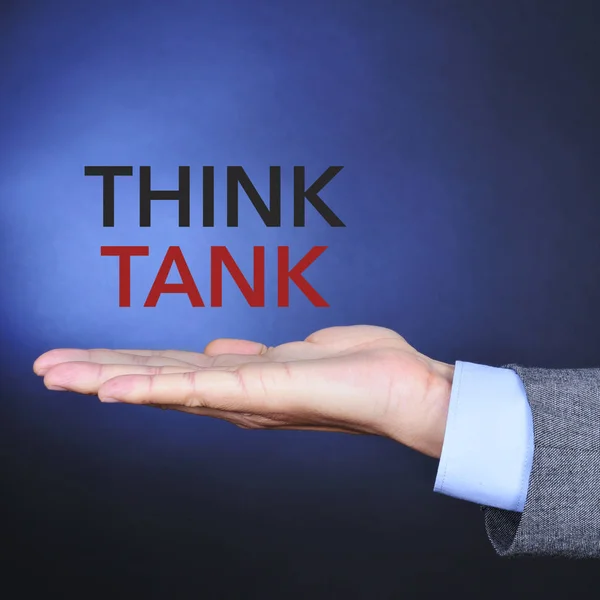 Think tank v rukou muže, text — Stock fotografie
