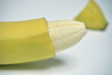 banana with the skin of its tip removed clipart