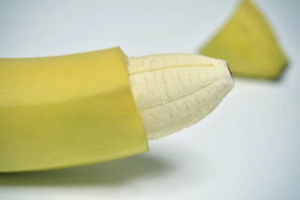 Banana with the skin of its tip removed — Stock Photo, Image