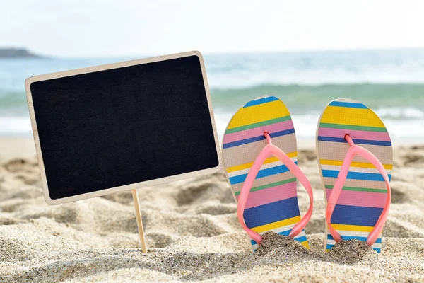 Blank black signboard on the beach — Stock Photo, Image