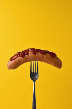 hot dog with ketchup in a fork clipart