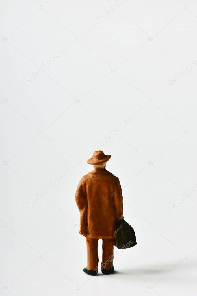 miniature traveler man with a suitcase