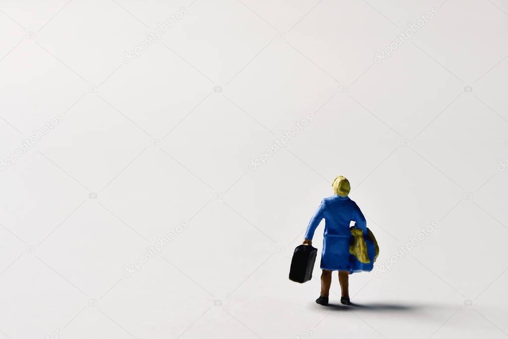 miniature traveler woman with suitcases
