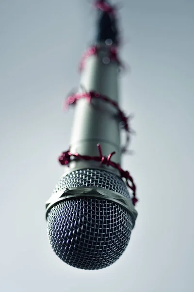 Barbed wire around a microphone — Stock Photo, Image