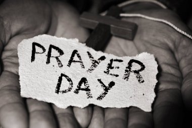 man with crucifix and text prayer day clipart