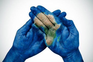 man hands patterned with a map of Africa (furnished by NASA) clipart