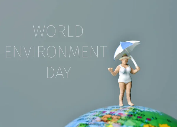 Miniature woman and text world environment day — Stock Photo, Image