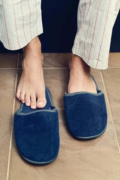 Young man putting on or off his slippers — Stock Photo, Image