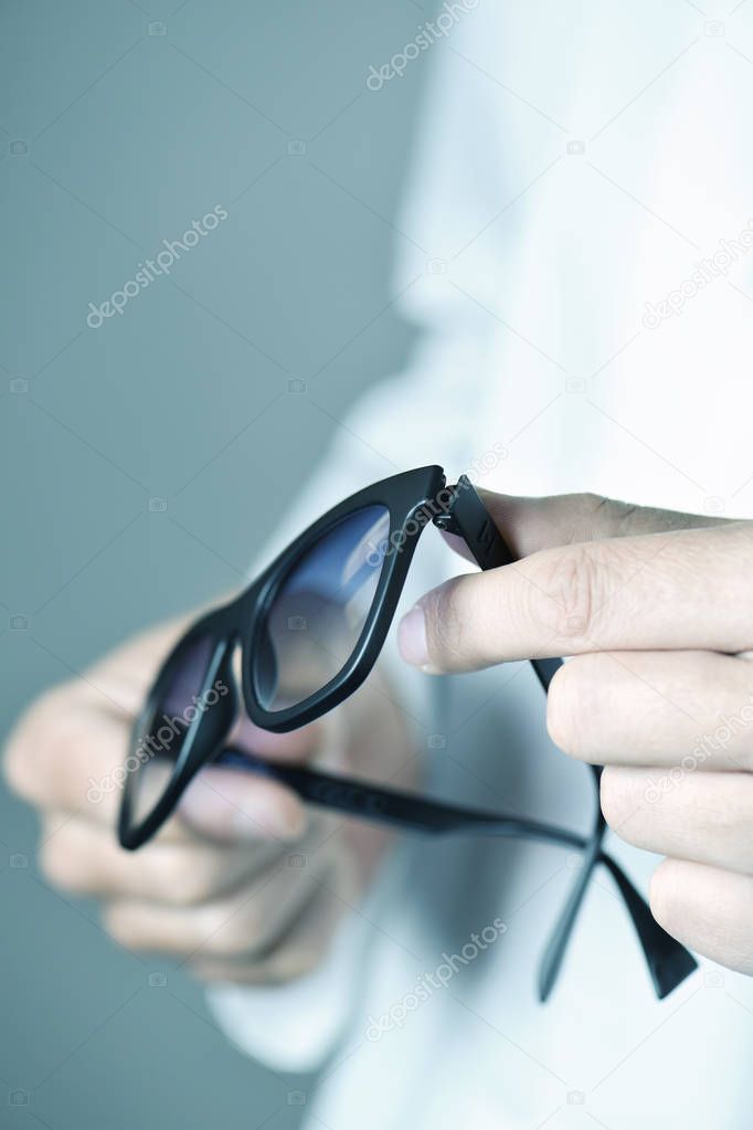 optician man with a pair of sunglasses