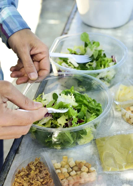 Jeune homme préparant une salade préparée — Photo