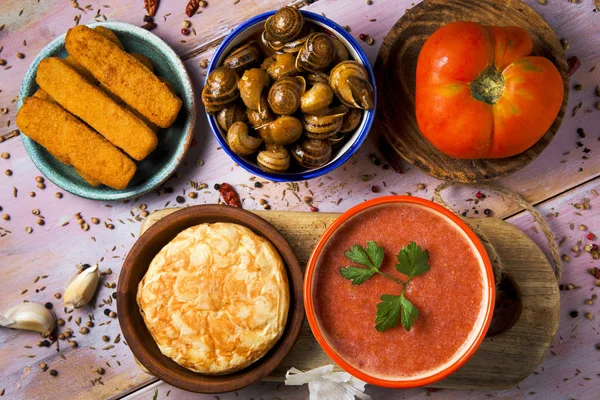 Spanish omelet, gazpacho, escargots, fish sticks — Stock Photo, Image