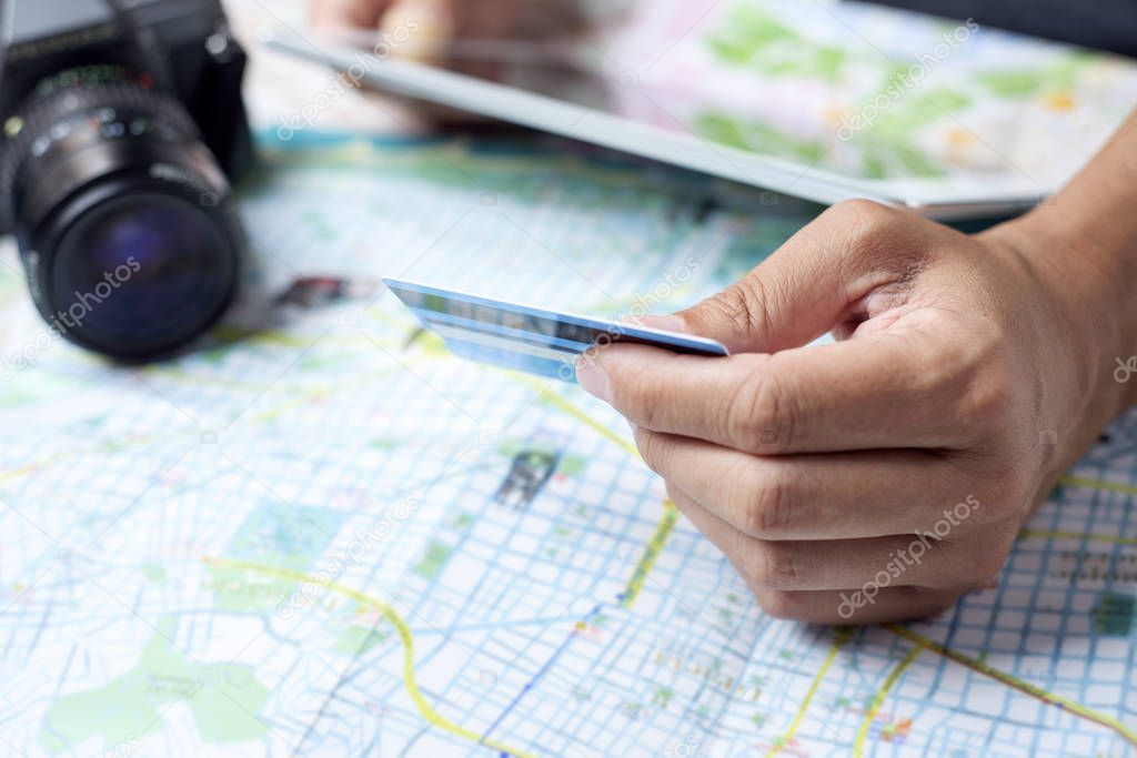 young man using a credit card to book a trip