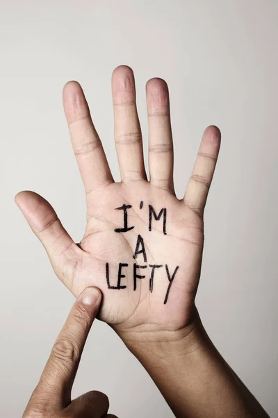 Text I am a lefty in the palm of the hand — Stock Photo, Image