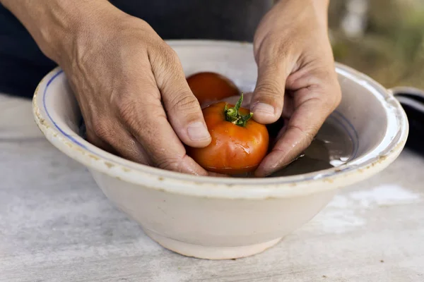 Joven limpieza algunos tomates —  Fotos de Stock