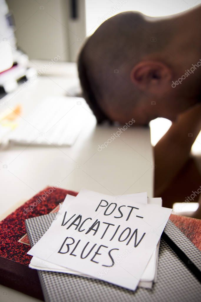man at office and text post-vacation blues