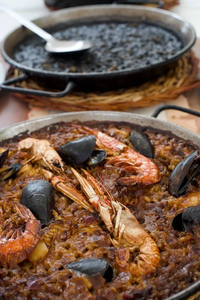 Paella española de mariscos y paella negra — Foto de Stock