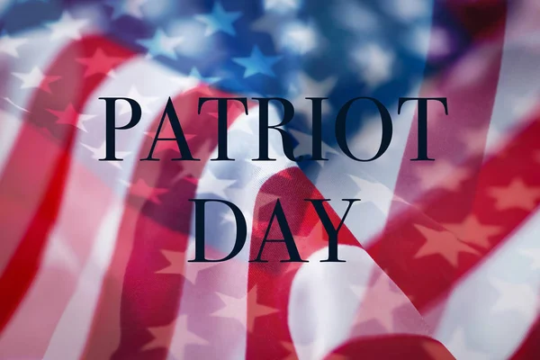 Americké vlajky a text patriot den — Stock fotografie