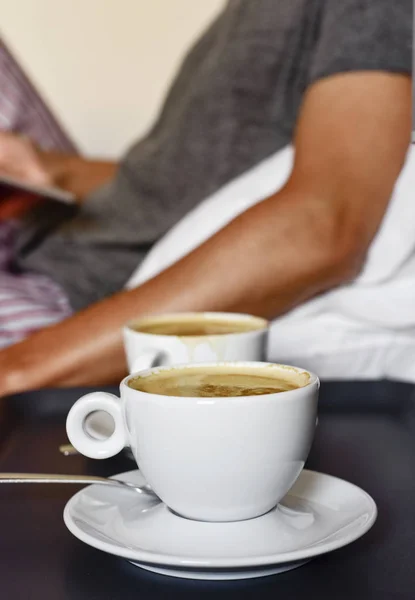 Young man with a coffee using a tablet — Stock Photo, Image