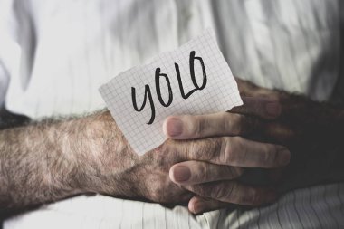old man with a note with the word yolo clipart