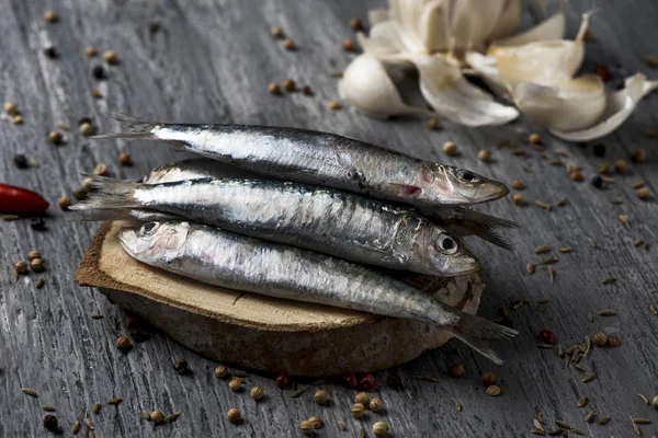 Raw sardines on a rustic wooden table — Stock Photo, Image