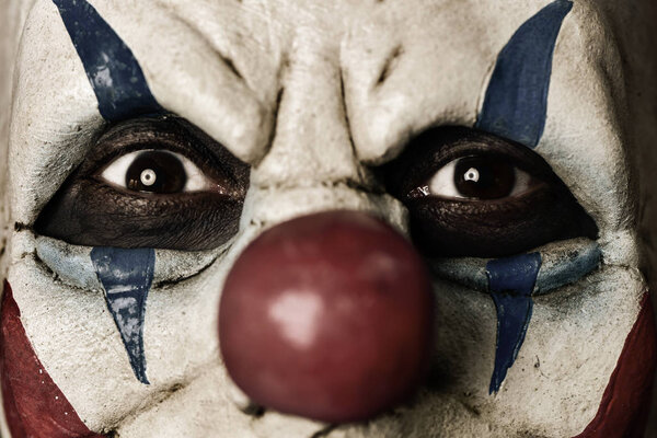 closeup of a scary evil clown