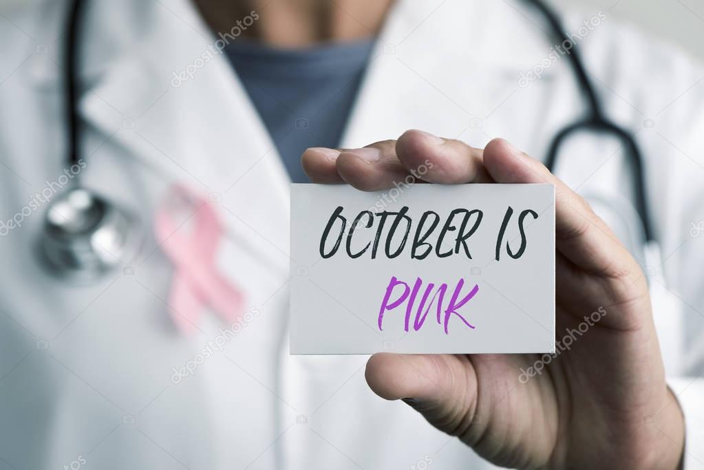 doctor and signboard with the text october is pink
