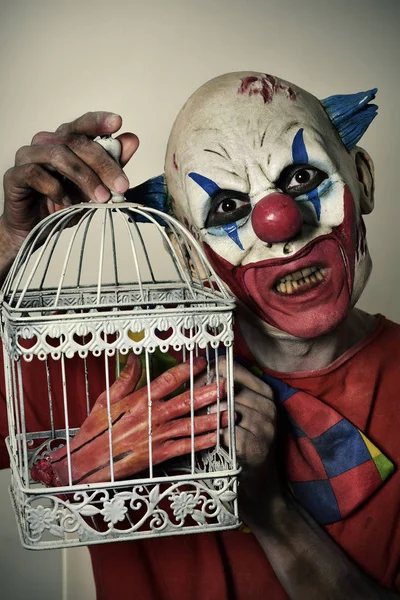 Scary evil clown with an amputated hand — Stock Photo, Image