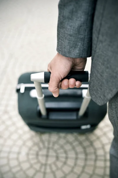 Businessman pulling a trolley case — Stock Photo, Image