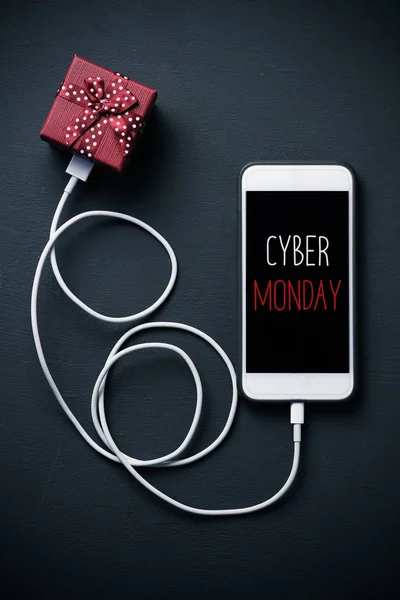 Gift and text happy cyber monday in a smartphone — Stock Photo, Image