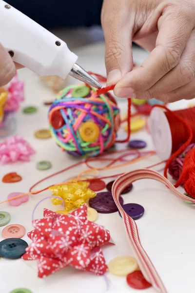 Man making a handmade christmas ball — Stock Photo, Image