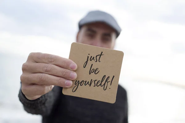 Man shows signboard with the text just be yourself — Stock Photo, Image