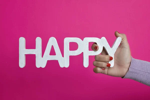 Young woman with the word happy in her hand — Stock Photo, Image