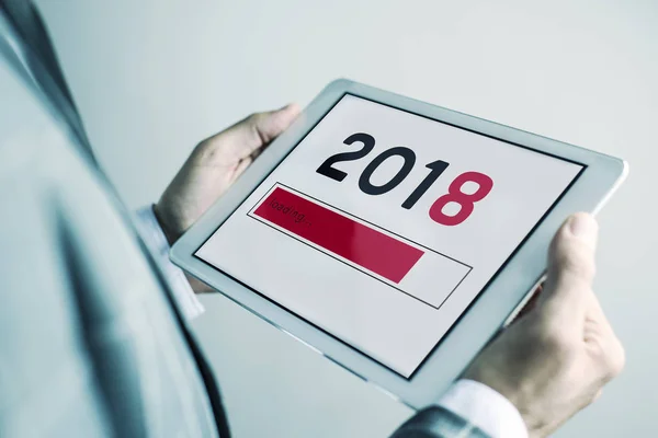 Man and number 2018, as the new year, in a tablet — Stock Photo, Image