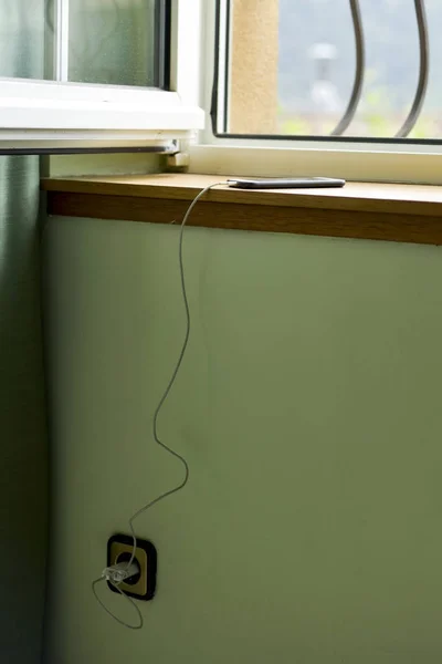 Smartphone plugged to a socket — Stock Photo, Image