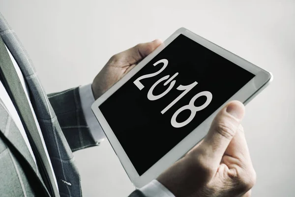 Man and number 2018, as the new year, in a tablet — Stock Photo, Image