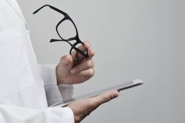 optician man checking a tablet clipart