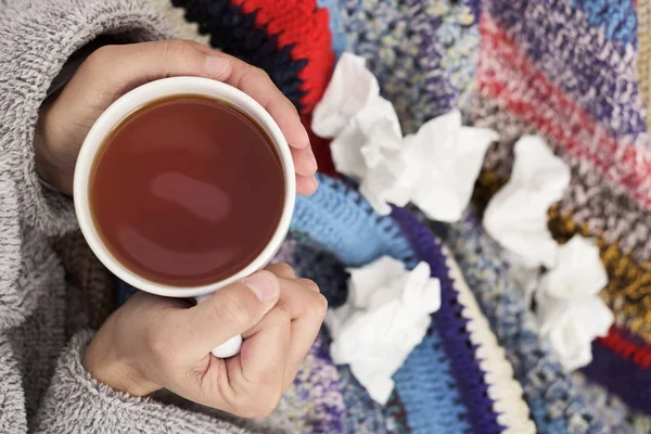 Ill man warming up with a cup of tea — Stock Photo, Image