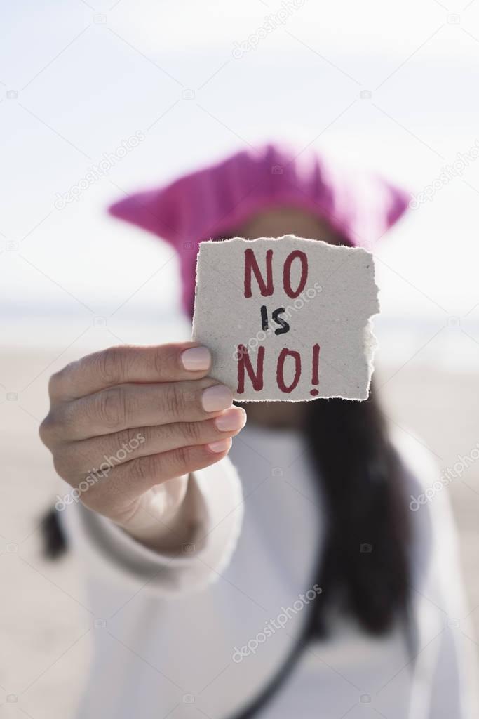 woman with a pussyhat and the text no is no