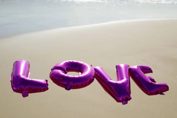 Letter-shaped balloons forming the word love — Stock Photo, Image