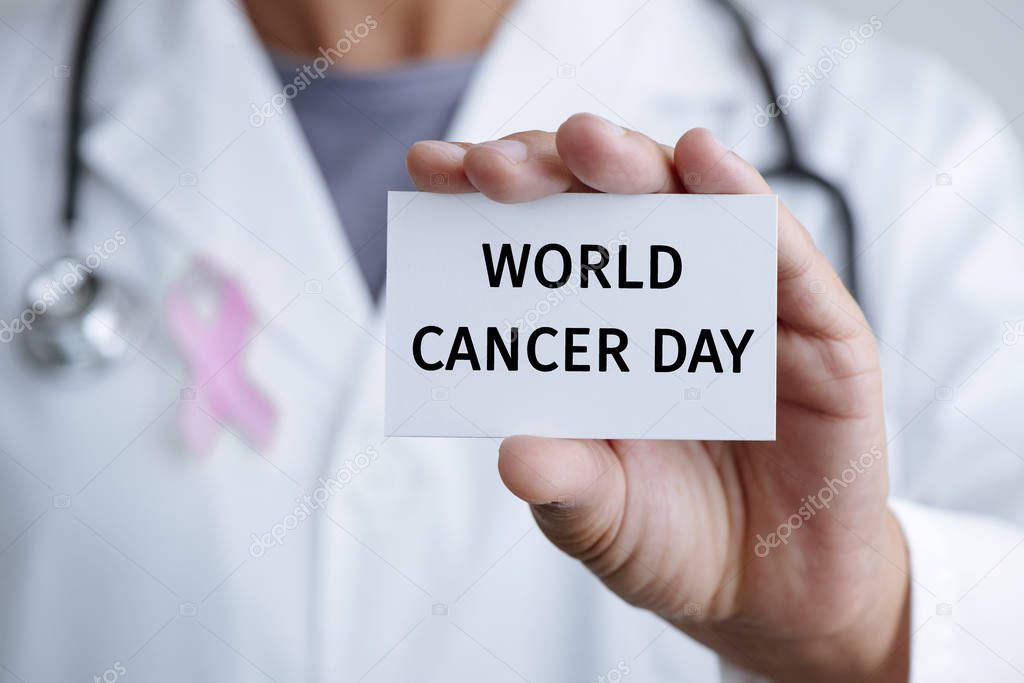 doctor and signboard with text world cancer day