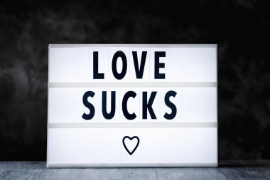 text love sucks in a lightbox clipart