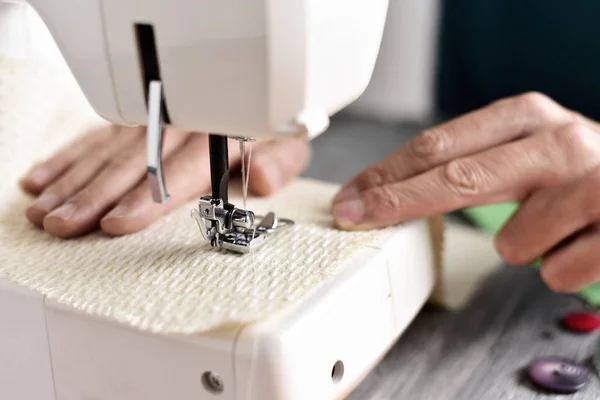 young man using a sewing machine