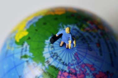 miniature traveler woman on the top the world clipart