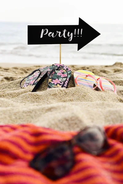 Word party in arrow-shaped signboard on the beach — Stock Photo, Image