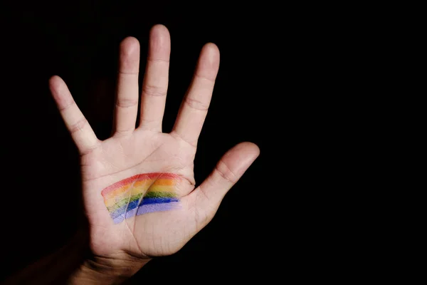 Hombre con una bandera de arco iris en la mano —  Fotos de Stock