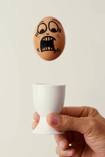 Brown egg with a scary face — Stock Photo, Image