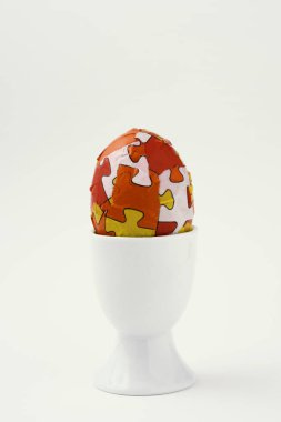 homemade decorated easter egg in an egg-cup clipart