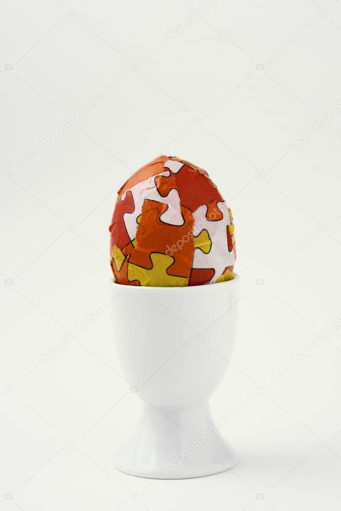 homemade decorated easter egg in an egg-cup